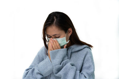 Young woman wearing hat against white background