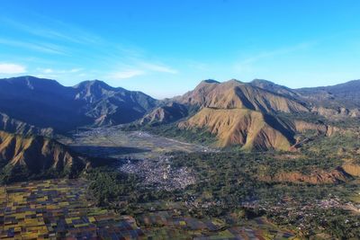 Scenic view of mountain range against blue sky