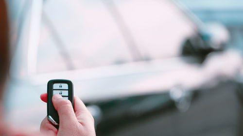 Cropped hand holding car key