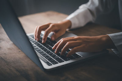 Midsection of man using laptop