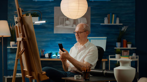 Portrait of young man using mobile phone