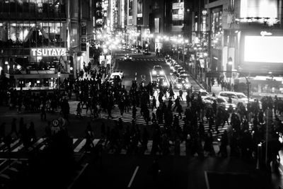 Crowd on city street at night