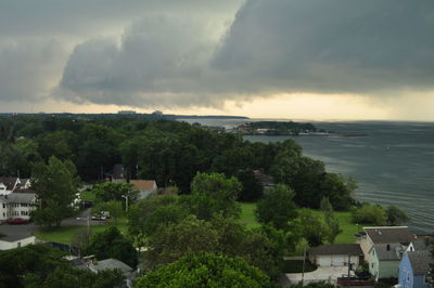 Scenic view of sea and cityscape against sky