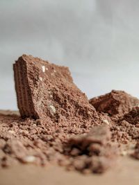 Close-up of bread on rock against sky