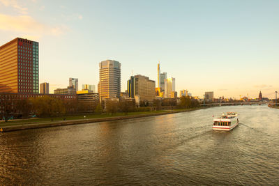 River amidst buildings in city against sky