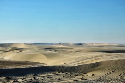 Scenic view of desert against clear blue sky