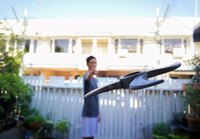 Woman standing by railing against sky