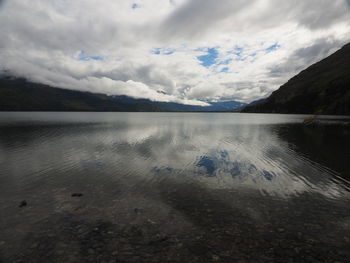 Scenic view of lake and mountains against sky
