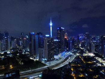 High angle view of city lit up at night