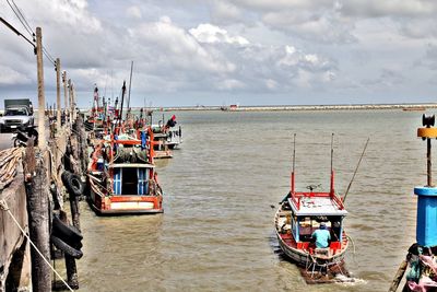 Boats in sea against sky