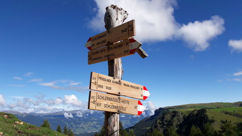 Low angle view of information sign against sky