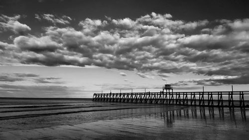 Pier over sea against sky