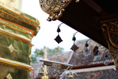 Low angle view of temple hanging on roof of building