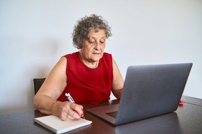 Man using mobile phone while sitting on table