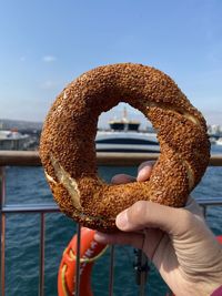 Cropped hand holding donut or bagel in turkey called lokma