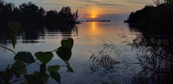 Scenic view of lake against sky during sunset