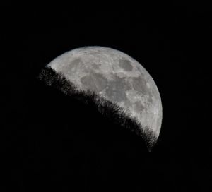 Low angle view of moon against clear sky at night