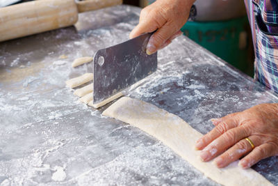 Cropped hand of person preparing food