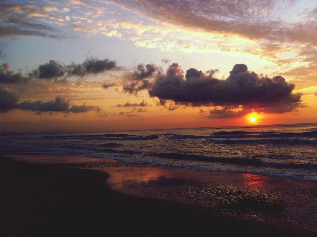 sunset, sea, beach, water, scenics, horizon over water, shore, beauty in nature, orange color, tranquil scene, sky, tranquility, idyllic, cloud - sky, nature, sun, wave, sand, coastline, outdoors