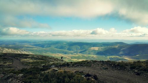 Scenic view of mountains against cloudy sky