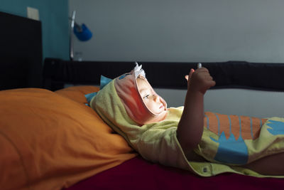 Midsection of man resting on bed at home