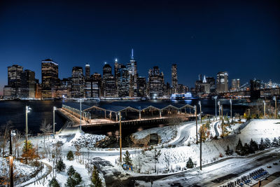 Illuminated buildings in city during winter