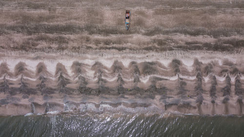 Aerial view of rowboat moored at beach