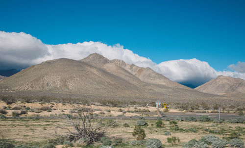 Scenic view of mountains against blue sky at death valley