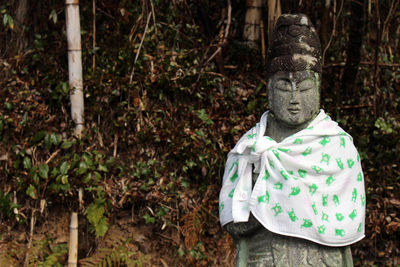 Statue of buddha against plants