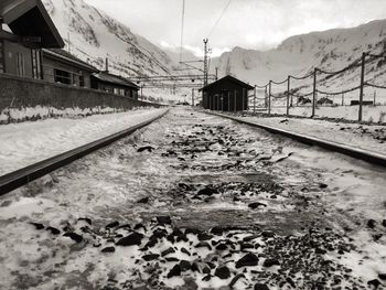 Railroad tracks in snow covered landscape