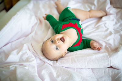 High angle view of boy sleeping on bed at home