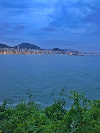 Scenic view of sea against sky in city