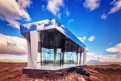 Built structure on landscape against blue sky