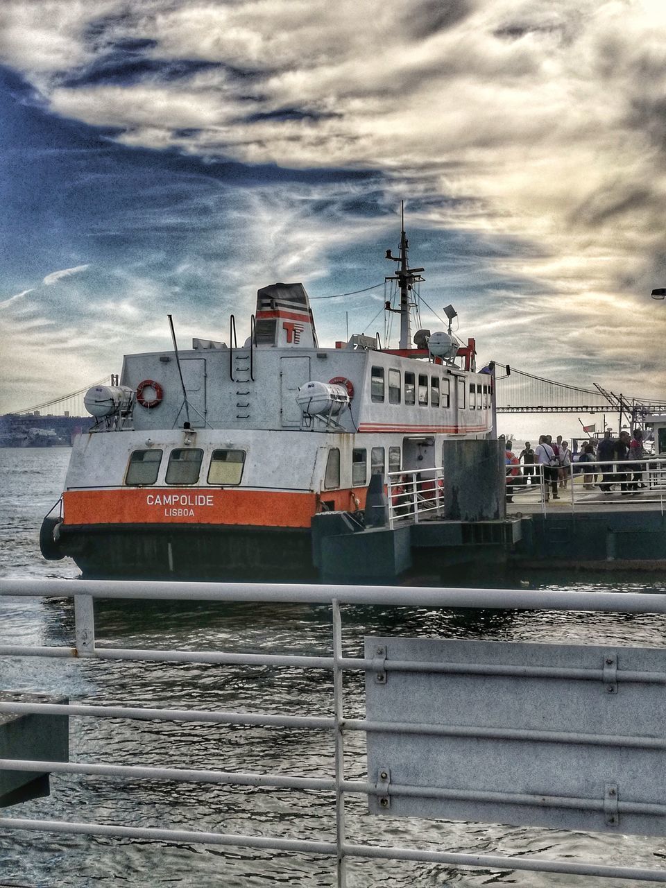 SHIP MOORED ON HARBOR AGAINST SKY