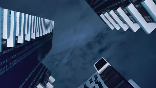 Low angle view of modern buildings in city against sky