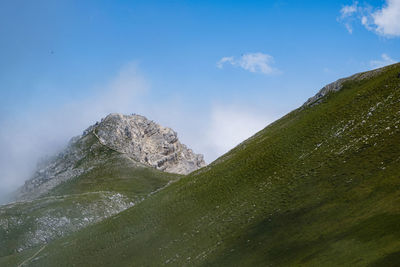 Scenic view of mountain against blue sky