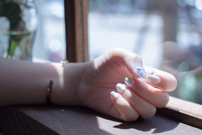 Close-up of woman hand on table