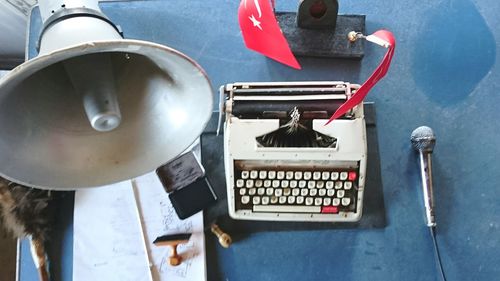 High angle view of megaphone by typewriter with turkish flag on table