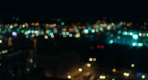 Defocused image of illuminated city at night