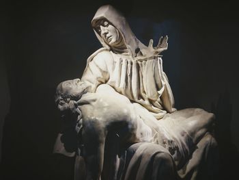 Low angle view of statue against black background