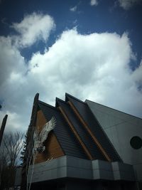 Low angle view of building against cloudy sky