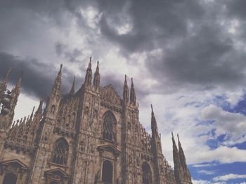 Low angle view of church against cloudy sky