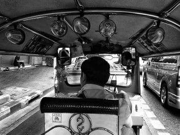 Rear view of a man driving auto rickshaw