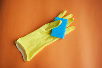 High angle view of glove and sponge on table