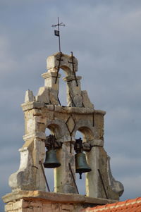 Low angle view of bell tower against sky