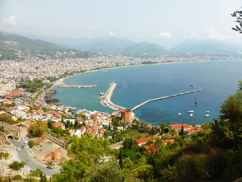 High angle view of buildings by sea against sky