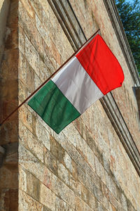 Low angle view of flag against building