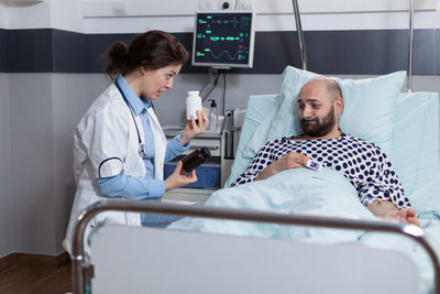 Female doctor prescribing medicine to doctor