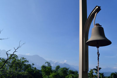 Low angle view of electric lamp against sky