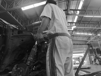 Low angle view of man working at construction site